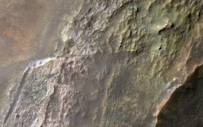 This image acquired on June 12, 2021 by NASA's Mars Reconnaissance Orbiter, shows layers in a kilometer-wide cutout, sloping from the crater's rim at right downward toward its floor off to the left.