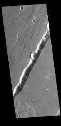 This image from NASA's Mars Odyssey shows part of Tantalus Catena, just one of many north/south trending tectonic graben located south and east of Alba Mons.