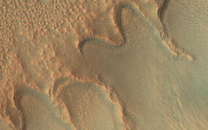 This image acquired on August 7, 2021 by NASA's Mars Reconnaissance Orbiter, shows curved, scalloped ridges, called moraines, that are made up of rocks that the glacier collected as it moved downslope.