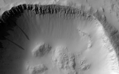 This image acquired on June 24, 2021 by NASA's Mars Reconnaissance Orbiter, shows an impact crater on the southeastern flank of Ascraeus Mons, a notable volcano in the Tharsis Plateau.