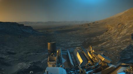 NASA's Curiosity Mars rover used its navigation cameras to capture panoramas of this scene. Blue, orange, and green color was added to a combination of the panoramas for an artistic interpretation of the scene.