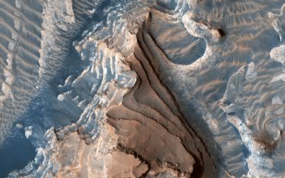 This image acquired on March 21, 2019 by NASA's Mars Reconnaissance Orbiter, shows an eroded mesa made up of rhythmically layered bedrock that seems to indicate cyclic deposition.