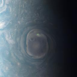 In this view of a vortex near Jupiter's north pole, NASA's Juno mission observed the glow from a bolt of lightning.