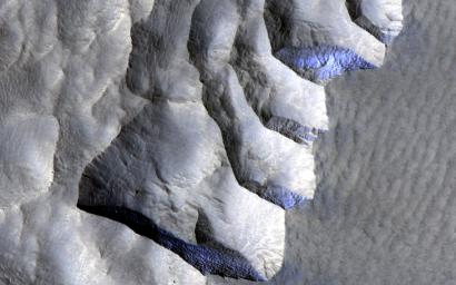This image acquired on November 2, 2021 by NASA's Mars Reconnaissance Orbiter, shows an area on the western edge of Milankovic Crater on Mars, that has a thick deposit of sediment covering a layer rich in ice.