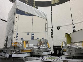 The Earth Surface Mineral Dust Source Investigation (EMIT) mission instrument (left) sits in the trunk that will travel aboard SpaceX's 25th cargo resupply mission.