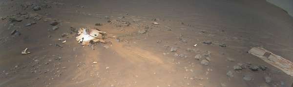 Perseverance's backshell, supersonic parachute, and associated debris field is seen strewn across the Martian surface in this image captured by NASA's Ingenuity Mars Helicopter during its 26th flight on April 19, 2022.
