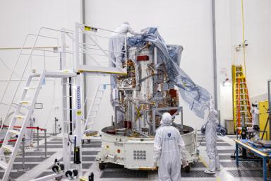 NASA's Europa Clipper spacecraft is being unwrapped in a main clean room at JPL, as engineers and technicians inspect it just after delivery in early June 2022.