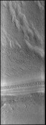 This image from NASA's Mars Odyssey shows part of the south polar cap. The sun has just risen on the cap as winter has transitioned into spring.