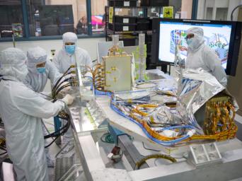 Engineers at NASA's Jet Propulsion Laboratory are shown assembling the electrical palette for the Coronagraph Instrument.