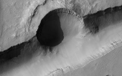 This image acquired on March 12, 2022 by NASA's Mars Reconnaissance Orbiter shows a crater that punched through the surface of Mars, revealing multiple layers formed previously below the surface.