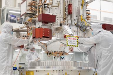 Engineers and technicians use a crane to lower the main body of NASA's Europa Clipper spacecraft into position in the High Bay 1 clean room of the Spacecraft Assembly Facility at the agency's Jet Propulsion Laboratory.