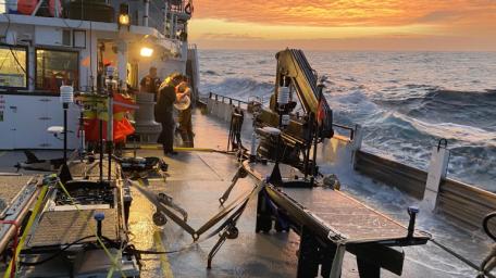 Autonomous wave gliders are seen being prepared for deployment on the deck of the research vessel Oceanus during the pilot campaign for NASA's Sub-Mesoscale Ocean Dynamics Experiment (S-MODE) in the Pacific Ocean off the U.S. West Coast.