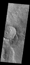 This image from NASA's Mars Odyssey shows an unusual layer of smooth material covering the flanks of the volcano Peneus Patera just south of the Hellas Basin.