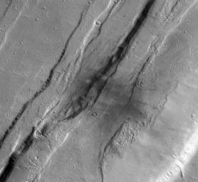 This meteoroid impact crater on Mars was captured using the black-and-white Context Camera aboard NASA's Mars Reconnaissance Orbiter (MRO).