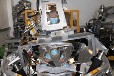 Amelia Quan, mechanical integration lead for NASA's SPHEREx mission, is seen with a V-groove radiator, a piece of hardware that will help keep the space telescope cold.