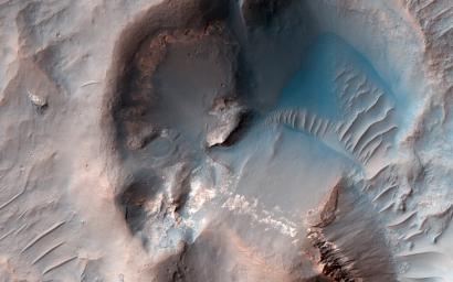 This image acquired on December 27, 2022 by NASA's Mars Reconnaissance Orbiter shows a small crater that appears to be partly-filled by deposits that have flowed into, and around it.