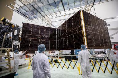 Technicians begin to retract one of the two solar arrays attached to NASA's Psyche spacecraft. This photo was taken on July 25, 2023.