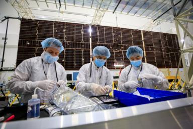 Team members prepare to integrate one of two solar arrays on NASA's Psyche spacecraft inside the Astrotech Space Operations facility near the agency's Kennedy Space Center in Florida on July 24, 2023.