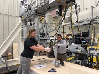 Engineers at NASA's Jet Propulsion Laboratory prepare flight-like landing gear in the Europa Lander landing gear testbed in summer 2022.