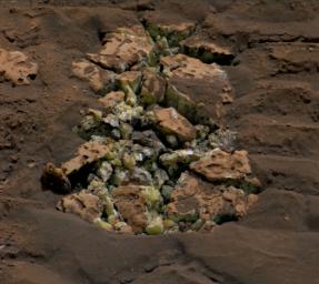 These yellow crystals were revealed after NASA's Curiosity happened to drive over a rock and crack it open on May 30. Using an instrument on the rover's arm, scientists later determined these crystals are elemental sulfur.
