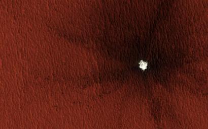 This image acquired on January 30, 2012 by NASA's Mars Reconnaissance Orbiter shows a 13-meter (43 feet) diameter crater in Arcadia Planitia where ice was exposed both in the crater interior and ejecta.