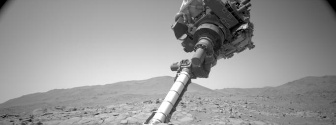 Imagery captured by a navigation camera aboard NASA's Perseverance rover shows the position of a cover on the SHERLOC instrument. The cover became stuck in January but the rover team has found a way to address the issue for continued operation.