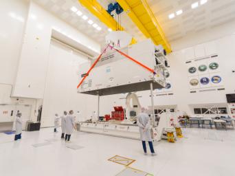 At NASA's Jet Propulsion Laboratory, on June 7, 2024, clean room technicians use a crane to lift the lid of the Medium Articulating Transportation System (MATS) that will be used for the components for NASA's NEO Surveyor mission.