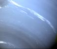 This image of the blue-hued Neptune was taken by NASA's Voyager 2; small trails of similar clouds trending east to west and large scale structure east of the Great Dark Spot all suggest that waves are present in the atmosphere and play a large role.