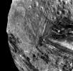 This image of the Uranian moon, Miranda, was taken Jan 24, 1986 by NASA's Voyager 2. This image reveals a bewildering variety of fractures, grooves and craters, as well as features of different albedos (reflectancea). 