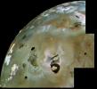 A huge area of Io's volcanic plains is shown in this archival image mosaic from NASA's Voyager 1. Numerous volcanic calderas and lava flows are visible here. Loki Patera, an active lava lake, is the large shield-shaped black feature. 
