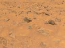 An area of rocky terrain and varied hues of soil is visible in the lower portion of this image, taken by NASA's Imager for Mars Pathfinder (IMP) on July 8, 1997. The lighter areas of soil may be partially composed of salts.