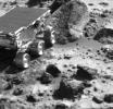 This image, taken by NASA's Imager for Mars Pathfinder (IMP) at the end of Sol 35, shows the Sojourner rover heading toward a rock called 'Wedge.' Sol 1 began on July 4, 1997.