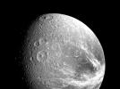 Many large impact craters are seen in this view of the Saturnian moon Dione taken by NASA's Voyager 1 on Nov. 12, 1980 from a range of about 240,000 kilometers (149,000 miles).