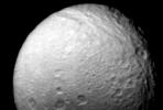 NASA's Voyager 2 obtained this view of Saturn's moon Tethys on Aug.25, 1981, from a distance of 540,000 kilometers (335,000 miles). It shows the numerous impact craters and fault valleys of a very ancient surface.