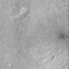 This picture is one of the first images obtained by NASA's Mars Global Surveyor following the May 1998 period of solar conjunction. The most striking feature in this image is the small crater with dark ejecta on the far right side.