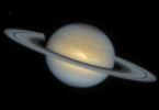 This NASA Hubble Space Telescope image, taken on Dec. 1, 1994, of the ringed planet Saturn shows a rare storm that appears as a white arrowhead-shaped feature near the planet's equator. 