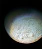 This color photo of Neptune's large satellite Triton was obtained on Aug. 24 1989. In reality, there is no part of Triton that would appear blue to the eye. The bright southern hemisphere of Triton, which fills most of this frame, is generally pink.
