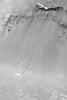 NASA's Mars Global Surveyor shows a portion of the slope just inside the south rim of Schiaparelli Basin near the martian equator. Boulders that apparently broke off the steep, dark cliff and rolled down the slope to the basin floor are evident.