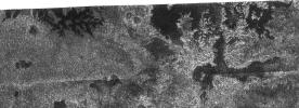 In this image taken by NASA's Cassini radar system, a previously unseen style of lakes is revealed. The lakes here assume complex shapes and are among the darkest seen so far on Titan.