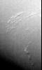 This image of Neptune's south polar region was obtained by NASA's Voyager on Aug. 23, 1989. The smallest cloud features are 45 kilometers (28 miles) in diameter. The image shows the discovery of shadows in Neptune's atmosphere, shadows cast onto a deep cl