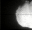 This frame from a movie was taken by Deep Impact's flyby spacecraft shows the flash that occurred when comet Tempel 1 ran over the spacecraft's probe. It was taken by the flyby craft's medium-resolution camera.
