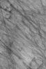 This image from NASA's Mars Global Surveyor shows dark streaks on a plain south of the giant impact basin, Hellas Planitia. The streaks map the routes traveled by dozens of individual southern spring and early summer dust devils.