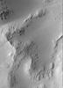 NASA's Mars Global Surveyor shows smooth, mantled surfaces, as well as bare, rocky surfaces on Mars.
