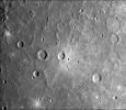 A dark, smooth, relatively uncratered area on Mercury was photographed two hours after NASA's Mariner 10 flew by the planet. The prominent, sharp crater with a central peak is 30 kilometers (19 miles) across.