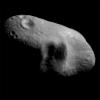 This image from NASA's NEAR Shoemaker shows asteroid Eros' saddle and a shadowed feature to its left, taken on March 3, 2000 from a distance of 127 miles. A shadowed feature that consists of three large craters are situated adjacent to each other.