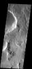 The many small channels dissecting the top part of this image are drainage valleys on Mars. Most are draining downhill to the top of the image as seen by NASA's 2001 Mars Odyssey.
