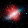 This infrared image from NASA's Spitzer Space Telescope shows a galaxy that appears to be sizzling hot, with huge plumes of smoke swirling around it. The galaxy is known as Messier 82 or the 'Cigar galaxy.'