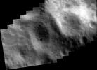 This image of asteroid Eros, taken by NASA's NEAR Shoemaker on May 14, 2000, shows bright patches at upper right that are relatively freshly exposed regolith on the inside wall of the crater.