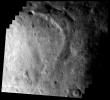 This image of asteroid Eros, taken by NASA's NEAR Shoemaker on May 17, 2000, shows the southern part of Eros' saddle with a wide, curved trough and bright area in the lower left section.