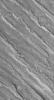 NASA's Mars Global Surveyor shows alternating ridges and troughs exposed by erosion of material interpreted to be sedimentary rock in the Aeolis region of Mars.